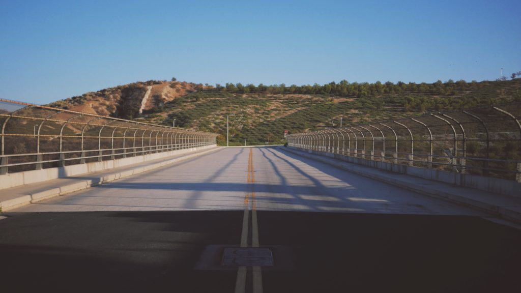 Shadows falling on a highway bridge with no traffic